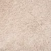 A close-up view of a beige shaggy rug. Anteprima dell’immagine prodotto