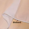 A close-up view of a white sheer curtain with a weighted hem, laid out on a wooden surface. Produktbild-Vorschau
