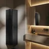 A modern bathroom with a black corner cabinet, a stone countertop with a sink, and a large illuminated mirror. Produktbild-Vorschau