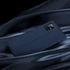 A dark blue flip cover case for a smartphone is displayed on a dark, draped fabric. Náhled obrázku produktu