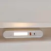 A close-up view of a white LED light strip with USB ports, integrated into a beige surface, likely part of a bed frame. Produktbild-Vorschau