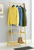 A yellow bamboo coat rack with clothes and shoes. Podgląd zdjęcia produktu