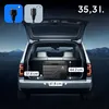 The back of an open SUV with a portable electric cooler inside, showing dimensions and power options. Anteprima dell’immagine prodotto