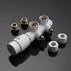 A white radiator valve with brass fittings and several hexagonal nuts is displayed on a dark reflective surface. Produktbild-Vorschau