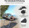 A woman relaxing on a sun lounger on a beach. Produktbild-Vorschau
