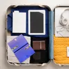 An open suitcase packed with travel essentials. Produktbild-Vorschau