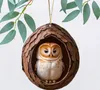 An owl ornament hanging from a branch. Produktbild-Vorschau