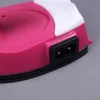 Close-up of a pink and white portable mini steam iron with a black electrical socket. Produktbild-Vorschau
