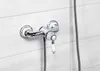 A chrome shower faucet with a white handle is mounted on a white tiled wall. Produktbild-Vorschau