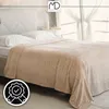 A beige, striped blanket is draped over a bed with white pillows. Anteprima dell’immagine prodotto