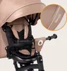 Close-up of a beige baby tricycle's canopy and handlebar area, with a magnified inset showing a detail of the fabric. Podgląd zdjęcia produktu
