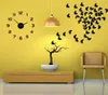 A decorative wall clock with butterfly decals and a small tree sculpture on a yellow wall. Náhled obrázku produktu