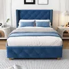 A blue upholstered bed with a tufted headboard and footboard, set in a bedroom with nightstands and artwork. Produktbild-Vorschau
