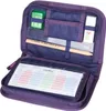 An open purple pencil case with various school supplies inside. Produktbild-Vorschau