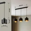 A collage showing a black pendant light fixture with dimensions and a lifestyle shot of the same fixture installed. Náhled obrázku produktu