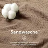 A close-up of a textured brown fabric with a cotton boll and text overlay. Produktbild-Vorschau