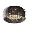 A close-up, studio shot of a round, modern chandelier with multiple glass droplets and a dark, reflective outer shell. Produktbild-Vorschau