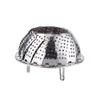 A stainless steel steamer basket with legs, isolated on a white background. Produktbild-Vorschau