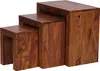 Three nesting tables made of dark brown wood are shown from a side angle. Voir les images du produit