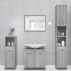 A bathroom vanity set with a sink, mirror, and storage cabinets against a tiled wall. Produktbild-Vorschau