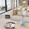 A modern living room with a sofa, coffee table, and a large window overlooking a snowy landscape. A humidifier is placed on the floor. Náhled obrázku produktu