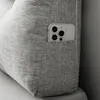 A close-up view of a grey fabric pillow with a smartphone in a side pocket. Produktbild-Vorschau