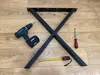 Table legs and assembly tools laid out on a wooden floor. Anteprima dell’immagine prodotto