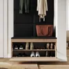 A shoe cabinet with a bench seat, featuring two shelves of shoes and coats hanging above. Produktbild-Vorschau