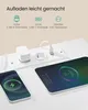 A white charging station with multiple ports and outlets, connected to a phone and a tablet that are charging. Produktbild-Vorschau