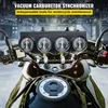 A close-up view of a motorcycle's handlebars with a vacuum carburetor synchronizer attached. Voir les images du produit