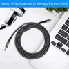 A coiled audio cable with a USB-C connector and a 3.5mm jack, placed next to a pair of headphones and a laptop. Produktbild-Vorschau