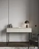 A minimalist desk with a lamp and books on top, set against a light gray wall. Anteprima dell’immagine prodotto