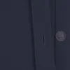 A close-up view of a dark blue fabric with a button and buttonhole. Podgląd zdjęcia produktu