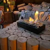 An outdoor patio setting with a modern tabletop fireplace. Náhľad obrázku produktu