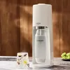 A white SodaStream Terra soda maker is shown next to a glass of sparkling water with fruit and a bunch of grapes. Produktbild-Vorschau