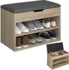 A shoe bench with storage shelves and a cushioned top, shown with shoes on the shelves and a small inset image showing the storage compartment open with cleaning supplies. Náhled obrázku produktu