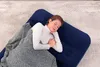 A woman sleeping on a navy blue air mattress with a gray blanket. Náhled obrázku produktu