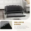 A dark gray pet sofa with a separate footrest on a rug in front of a white cabinet and a gray armchair. Náhled obrázku produktu
