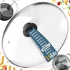 A glass pot lid with a size guide attached to the handle, with food items in the background. Produktbild-Vorschau