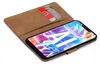 A book-style phone case with cards inserted, showing the phone screen with a colorful abstract wallpaper. Anteprima dell’immagine prodotto