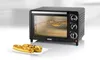 A small black toaster oven with three pizzas baking inside, and two baked subs on a white plate in front of it. Náhled obrázku produktu