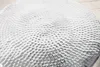 A close-up view of a round, hammered metal table surface. Produktbild-Vorschau