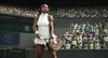 A female tennis player stands on a court with a crowd in the background. Produktbild-Vorschau