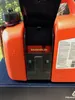 Close-up of an orange Husqvarna combination canister for fuel and oil. Voir les images du produit