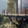 A rope ladder is hanging from a balcony of a modern house, surrounded by trees and mountains. Náhled obrázku produktu