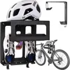 A bicycle helmet, cycling shoes, and a bicycle are displayed with a black metal storage rack. Náhled obrázku produktu