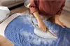 A person ironing a blue garment on an ironing board. Voir les images du produit