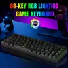 A gaming keyboard with RGB lighting is displayed on a desk with a computer monitor and headphones in the background. Produktbild-Vorschau