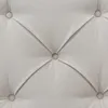 A close-up view of a tufted fabric surface with buttons. Produktbild-Vorschau