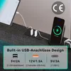 A close-up view of a charging station with multiple USB ports and a wireless charging pad for a phone, placed on a textured surface. Produktbild-Vorschau